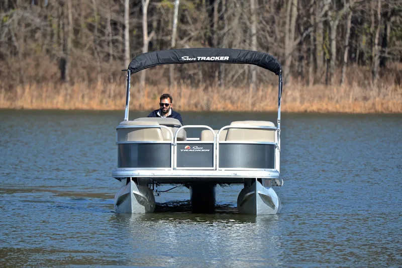 Slide: The Image of 2025 Sun Tracker Party Barge 18 DLX pontoon boat on a serene lake. - 9