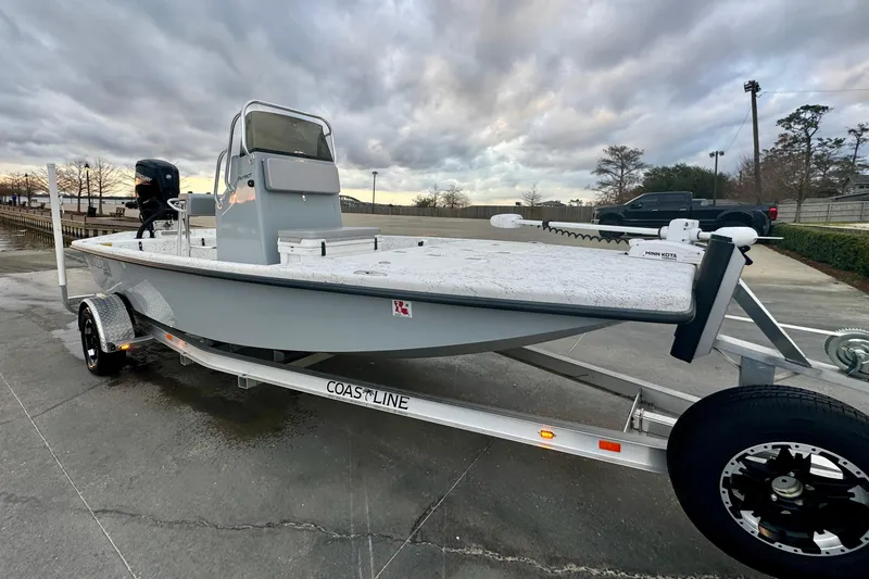 Slide: The Image of 2025 Freedom Boats 18' Patriot on trailer, cloudy sky. - 13