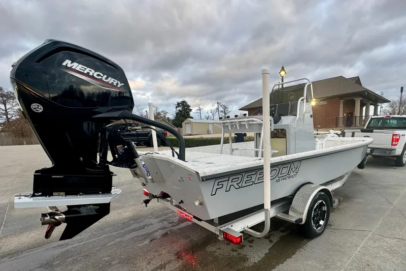 Slide: The Image of 2025 Freedom Boats 18' Patriot with Mercury engine on trailer. - 15