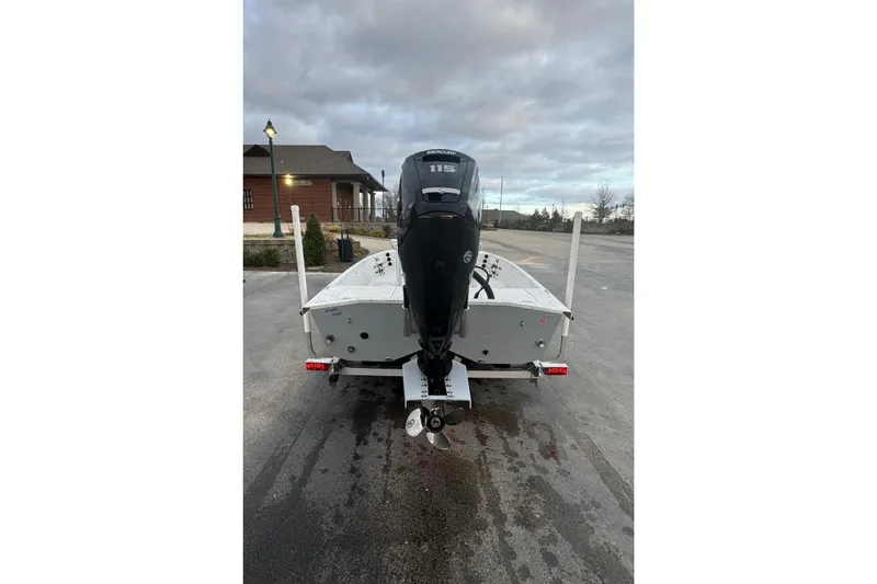 Slide: The Image of Rear view of 2025 Freedom Boats 18' Patriot with outboard motor. - 18