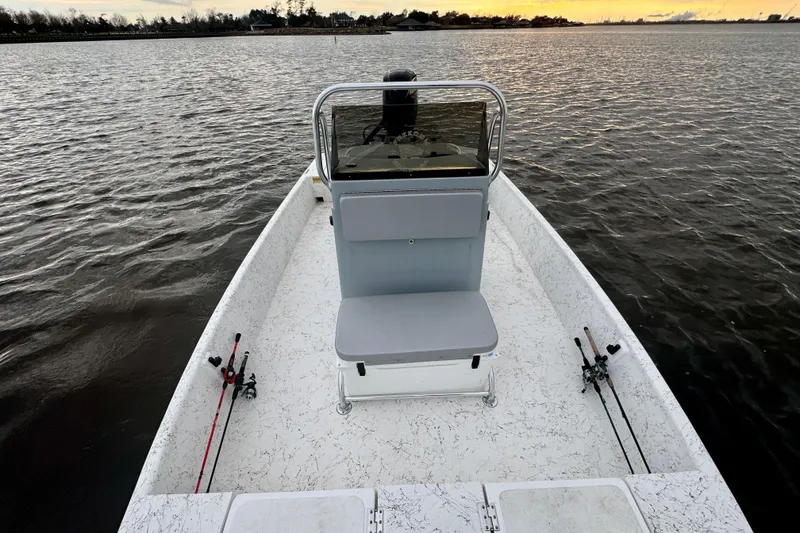 Slide: The Image of Freedom Boats 18' Patriot 2025 on calm water at sunset. - 22