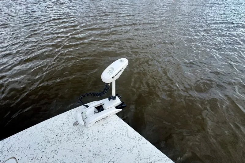 Slide: The Image of Freedom Boats 18' Patriot 2025 with Minn Kota motor on water. - 23