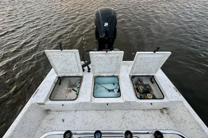 Slide: The Image of Freedom Boats 18' Patriot 2025 with open storage compartments on water. - 28