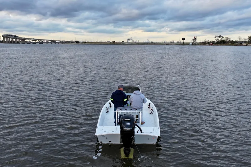 Slide: The Image of Two people on a Freedom Boats 18' Patriot on the water. - 11