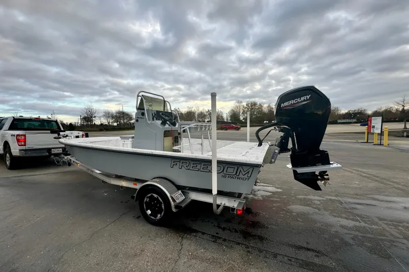 Slide: The Image of 2025 Freedom Boats 18' Patriot with Mercury engine on trailer. - 19