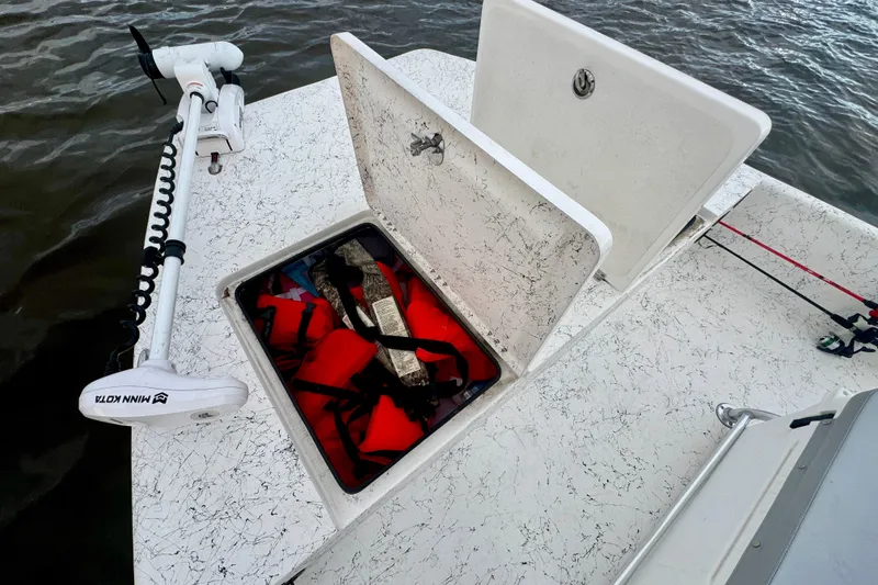 Slide: The Image of 2025 Freedom Boats 18' Patriot with storage compartment and Minn Kota motor. - 24