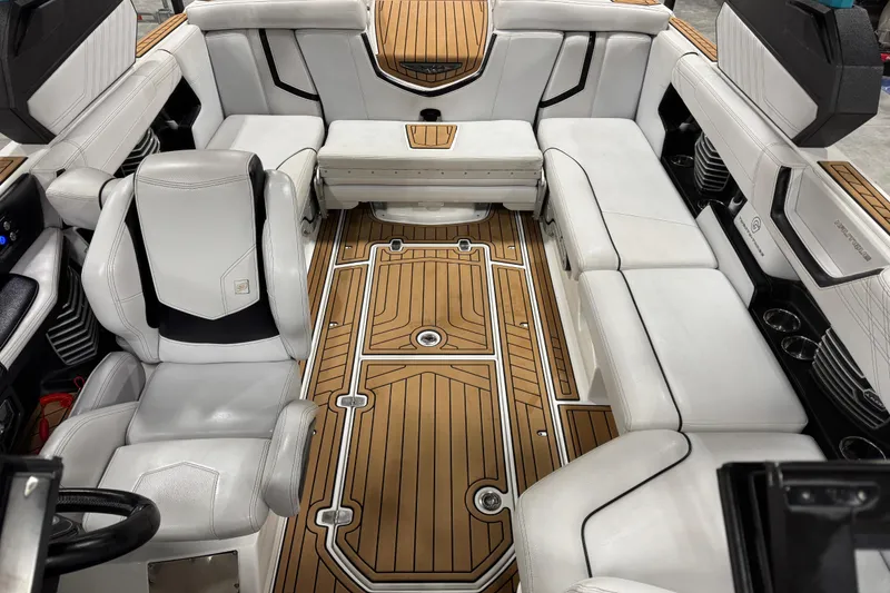 Slide: The Image of 2019 Nautique Super Air Nautique G23 interior with white seating and teak flooring. - 10