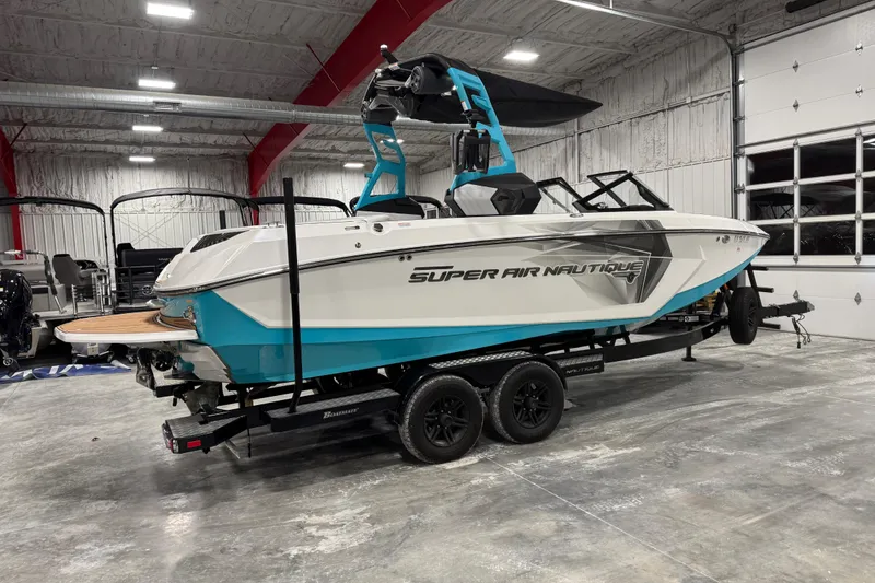 Slide: The Image of 2019 Nautique Super Air Nautique G23 boat in a garage on a trailer. - 3