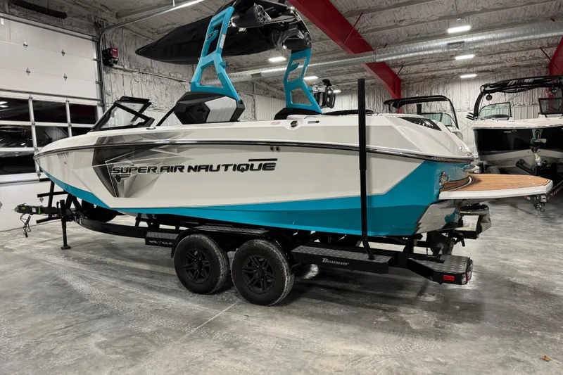 Slide: The Image of 2019 Nautique Super Air Nautique G23 boat in a showroom on a trailer. - 4