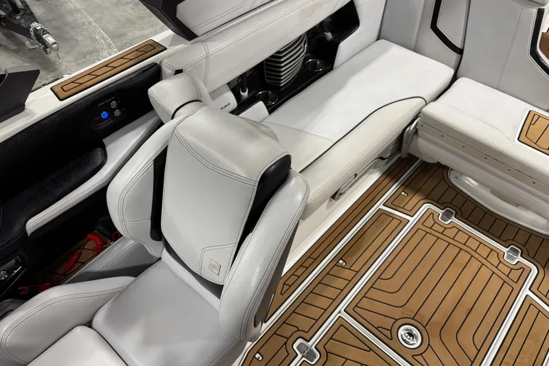 Slide: The Image of 2019 Nautique Super Air Nautique G23 interior with white leather seats and teak-style flooring. - 8