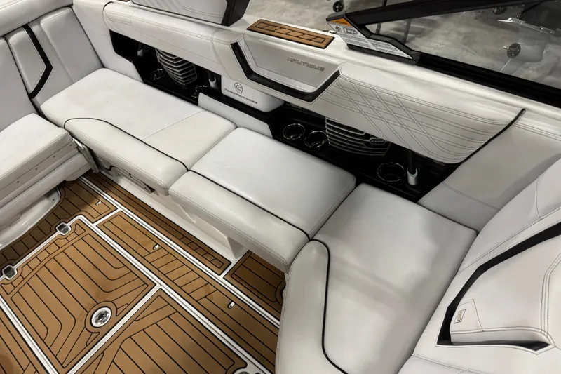 Slide: The Image of 2019 Nautique Super Air Nautique G23 interior with white seating and teak-style flooring. - 9