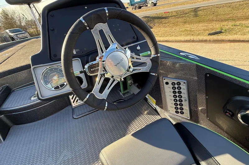 Slide: The Image of 2021 Caymas CX 21 boat dashboard with steering wheel and control panel. - 14
