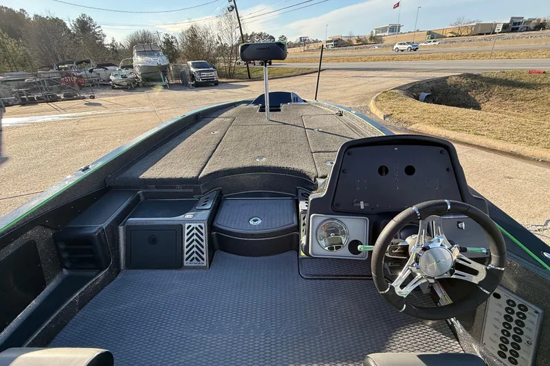 Slide: The Image of 2021 Caymas CX 21 boat interior with steering wheel and dashboard, parked outdoors. - 15