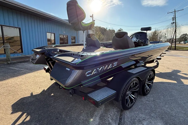 Slide: The Image of 2021 Caymas CX 21 boat on trailer, parked outside a blue building under clear sky. - 3