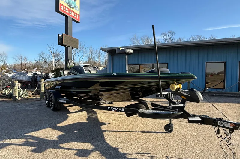Slide: The Image of 2021 Caymas CX 21 boat on trailer, parked outside a blue building under clear skies. - 5