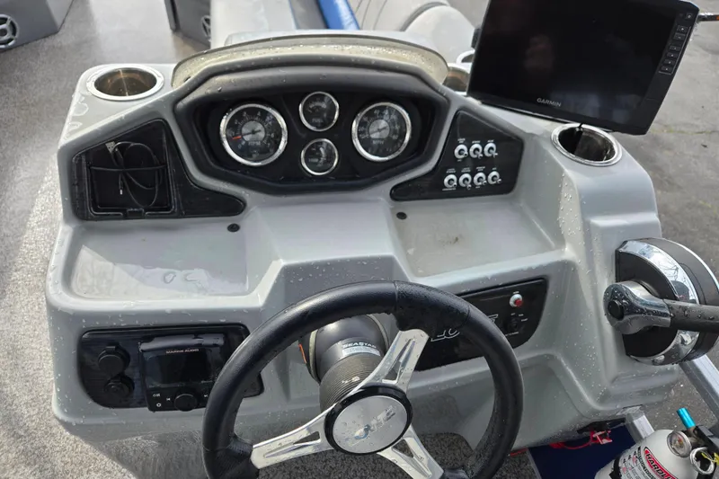 Slide: The Image of 2020 Lowe SF 232 Sport Fish boat dashboard with steering wheel and control panel. - 11