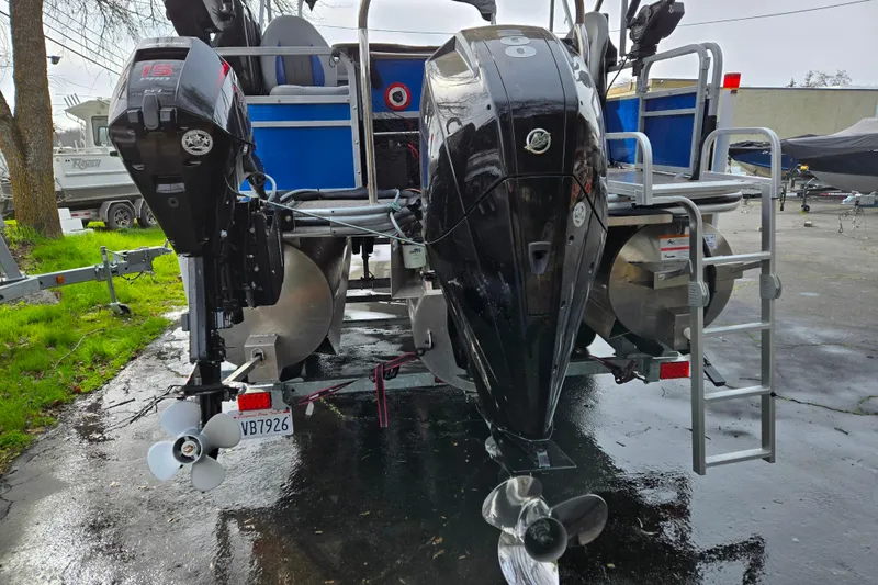 Slide: The Image of 2020 Lowe SF 232 Sport Fish boat with dual outboard motors and ladder. - 4