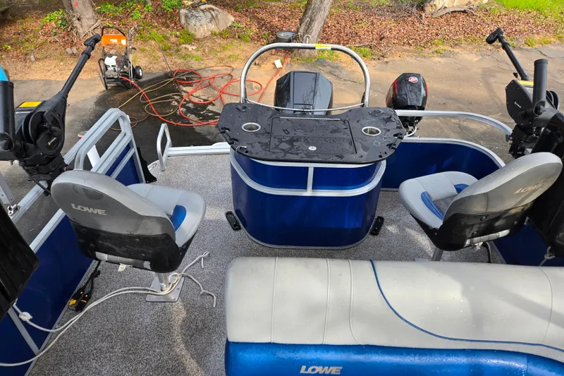 Slide: The Image of 2020 Lowe SF 232 Sport Fish boat interior with seating and fishing equipment. - 8
