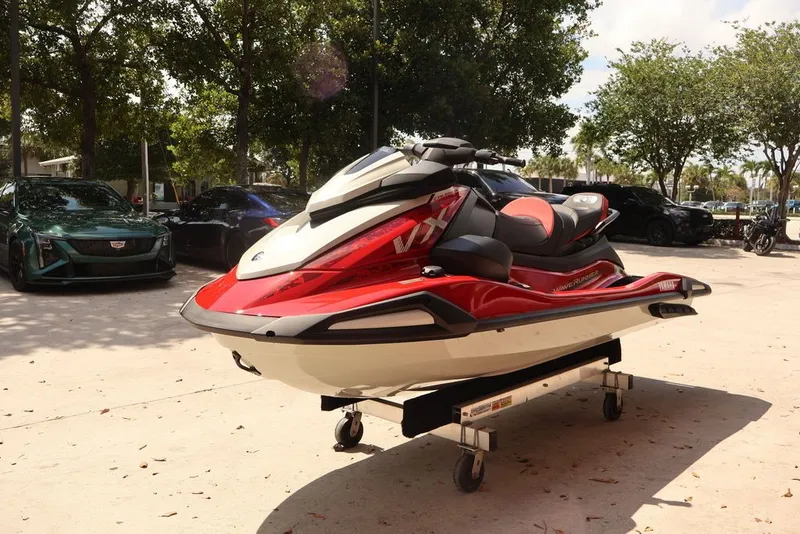 Slide: The Image of 2026 Yamaha WaveRunners VX Cruiser with Audio, red, displayed outdoors. - 2