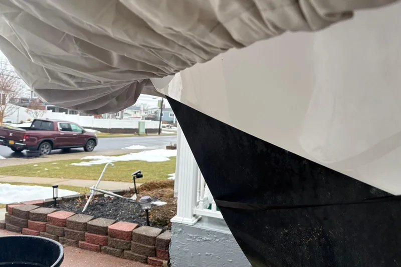Slide: The Image of Covered Dusky 227 boat in snowy suburban driveway, 2025 model. - 10