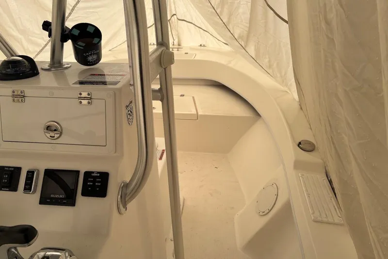 Slide: The Image of Interior of 2025 Dusky 227 boat, featuring control panel and seating area. - 4