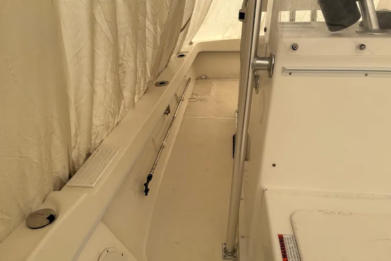 Slide: The Image of Interior view of a 2025 Dusky 227 boat, showcasing seating and railing details. - 5