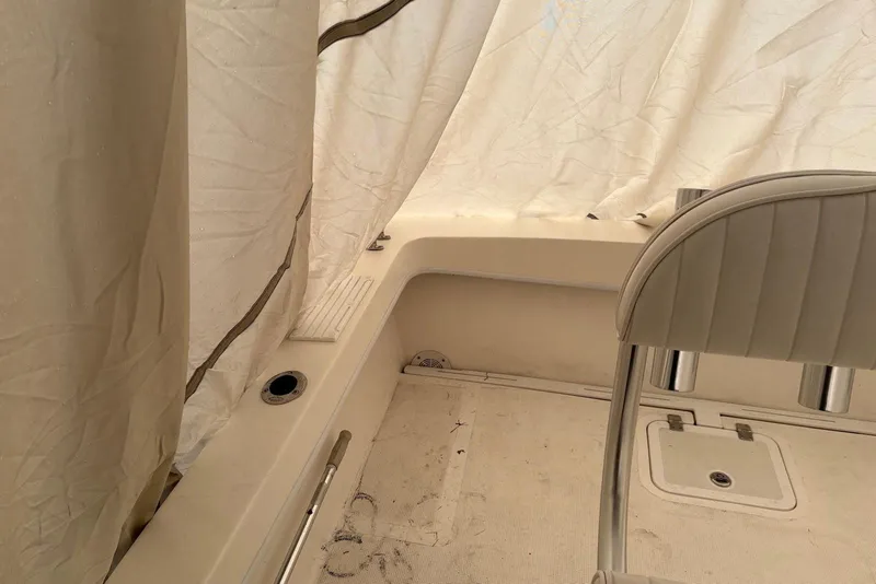 Slide: The Image of Interior of a 2025 Dusky 227 boat with seating and covered area. - 6
