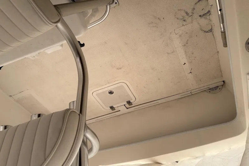 Slide: The Image of Interior view of a 2025 Dusky 227 boat, featuring seating and storage compartments. - 7