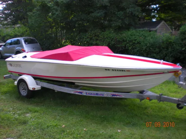 Slide: The Image of 2008 Donzi 18 Classic boat with red cover on trailer. - 0