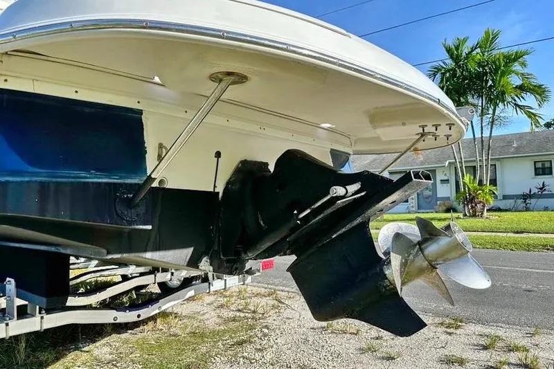 Slide: The Image of 2005 Four Winns 264 Funship boat stern with propeller, parked on a trailer. - 11