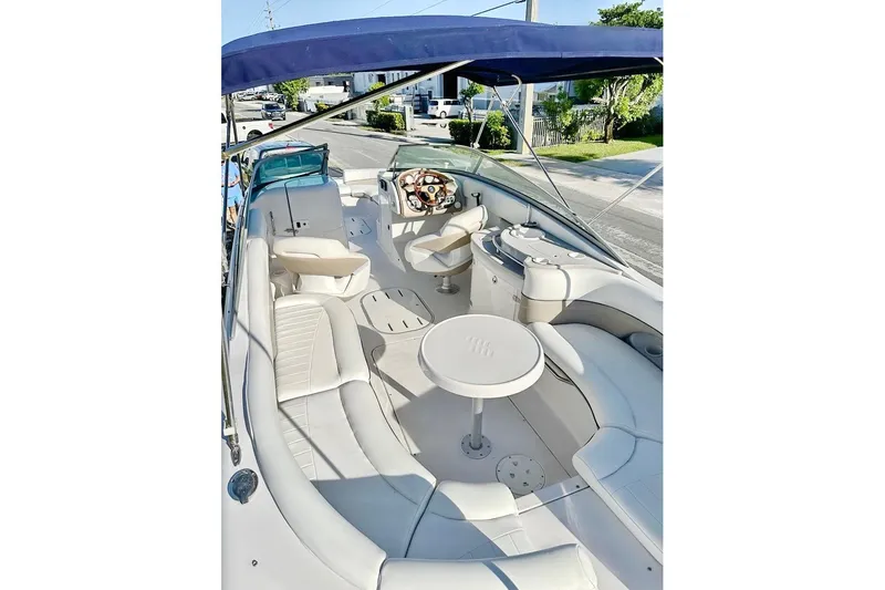 Slide: The Image of 2005 Four Winns 264 Funship boat interior with seating, table, and steering wheel. - 15