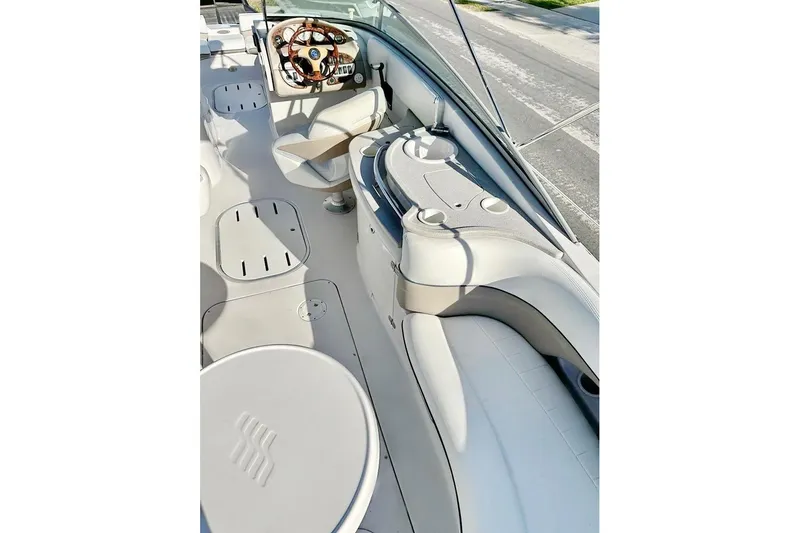 Slide: The Image of 2005 Four Winns 264 Funship boat interior with steering wheel and seating area. - 16