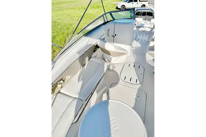 Slide: The Image of 2005 Four Winns 264 Funship boat interior with white seating and open deck layout. - 17