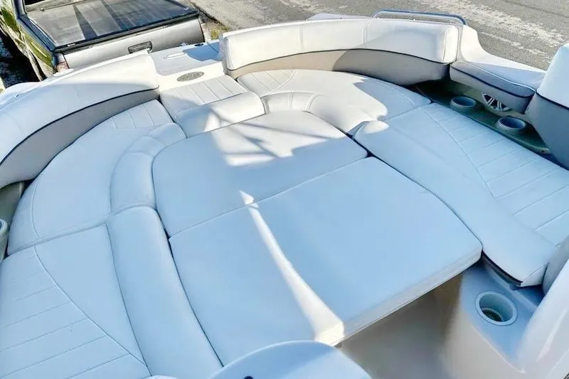 Slide: The Image of 2005 Four Winns 264 Funship boat interior with spacious white seating and cup holders. - 25