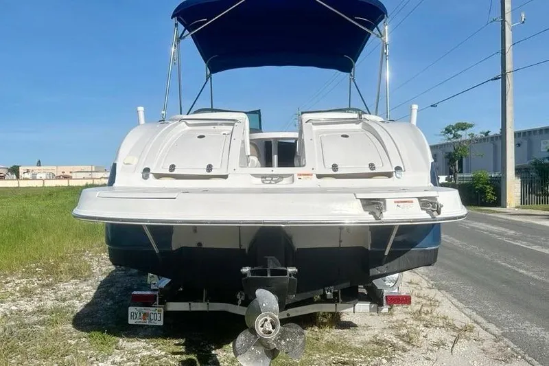 Slide: The Image of 2005 Four Winns 264 Funship boat with blue canopy, rear view on trailer. - 4