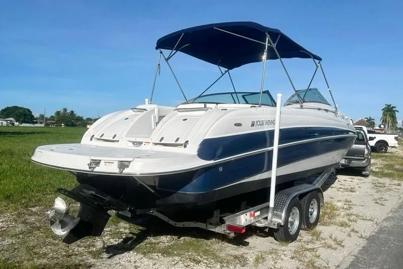 Slide: The Image of 2005 Four Winns 264 Funship boat on trailer with blue canopy, parked outdoors. - 5