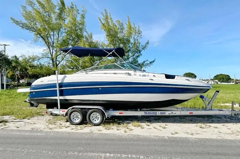 Slide: The Image of 2005 Four Winns 264 Funship boat on trailer, parked outdoors, sunny day. - 6