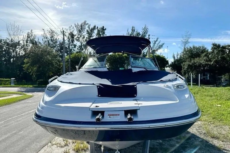 Slide: The Image of 2005 Four Winns 264 Funship boat with cover, parked on a sunny day. - 9