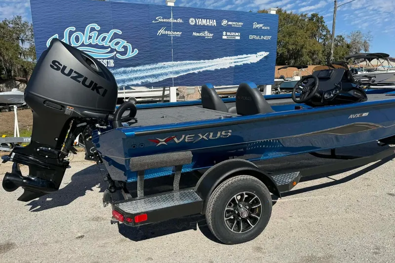 Slide: The Image of 2026 Vexus Defender 189 boat with Suzuki outboard motor on display. - 2