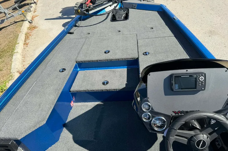 Slide: The Image of 2026 Vexus Defender 189 boat interior with steering console and carpeted deck. - 3