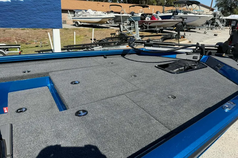 Slide: The Image of 2026 Vexus Defender 189 boat deck with storage compartments and trolling motor. - 4