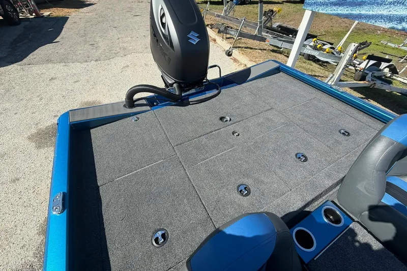 Slide: The Image of 2026 Vexus Defender 189 boat deck with Suzuki motor, featuring carpeted surface and seating. - 5