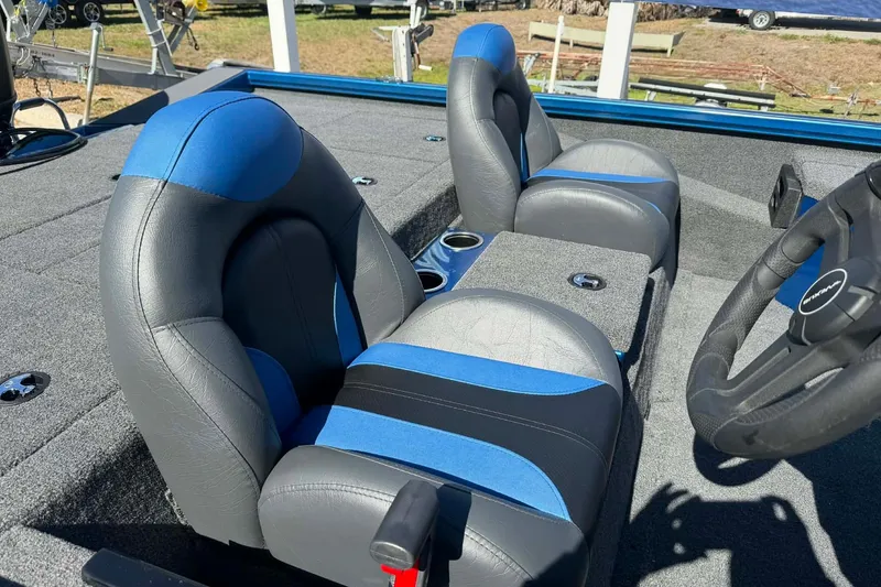 Slide: The Image of 2026 Vexus Defender 189 boat interior with blue and gray seating and steering wheel. - 9