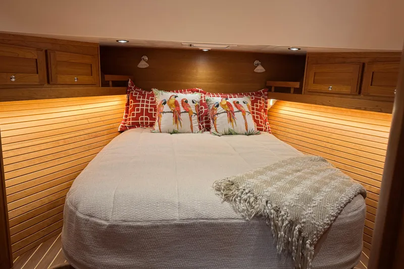 Slide: The Image of Cozy bedroom in 2023 Sabre 48 Salon Express yacht with decorative pillows and warm lighting. - 17