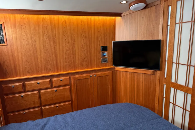 Slide: The Image of Luxurious 2023 Sabre 48 Salon Express interior with wood paneling and mounted TV. - 22
