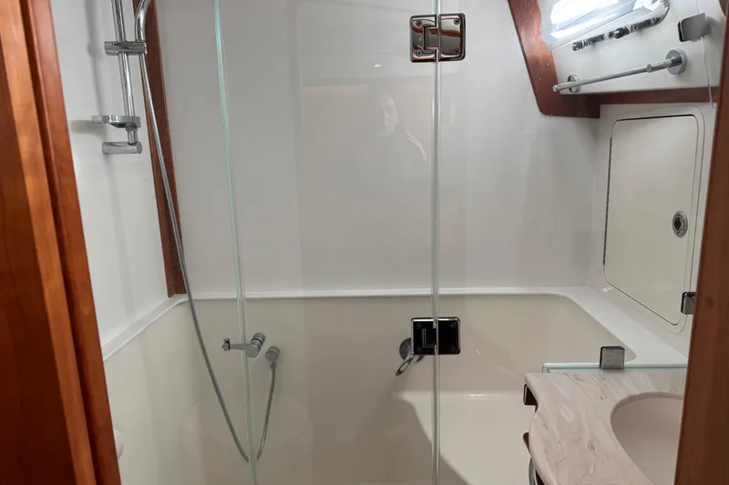 Slide: The Image of Modern bathroom in 2023 Sabre 48 Salon Express yacht with glass shower enclosure. - 23