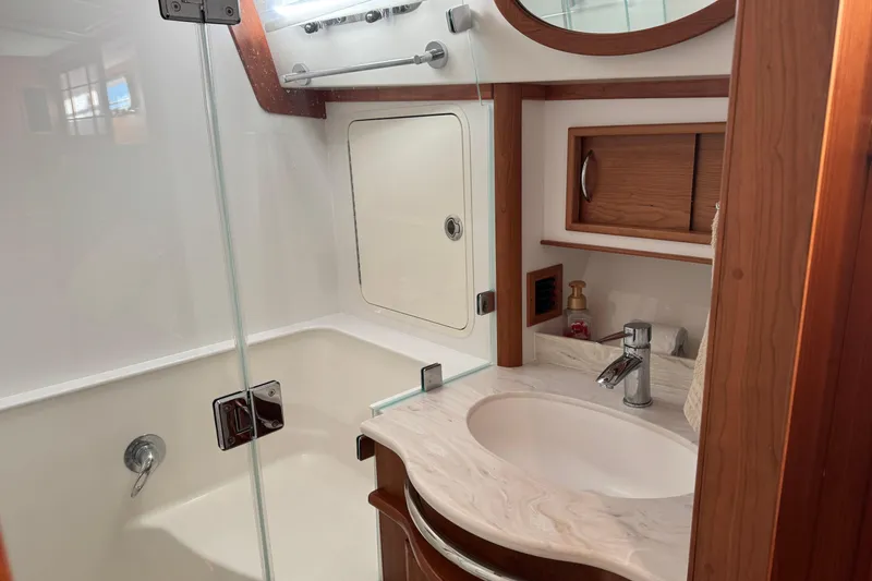 Slide: The Image of 2023 Sabre 48 Salon Express bathroom with modern sink and shower design. - 24