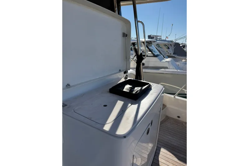 Slide: The Image of 2023 Sabre 48 Salon Express yacht deck with open storage compartment. - 5