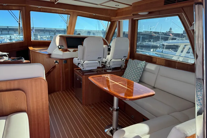 Slide: The Image of Interior of 2023 Sabre 48 Salon Express yacht with elegant seating and helm station. - 9