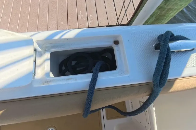 Slide: The Image of 2020 Velocity 262cc boat with rope storage compartment and cleat on deck. - 22